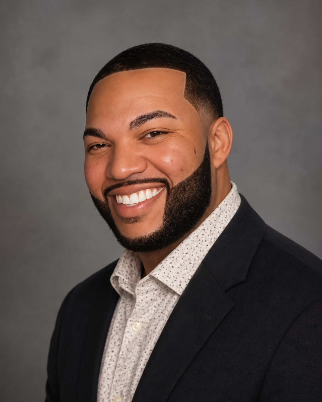 Jordan Woodson smiling in a professional portrait
